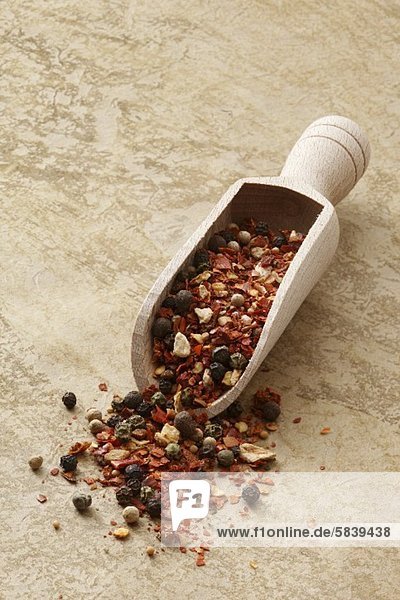 Mexican spice mixture in a wooden scoop