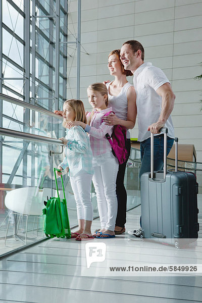 Family in airport with luggage