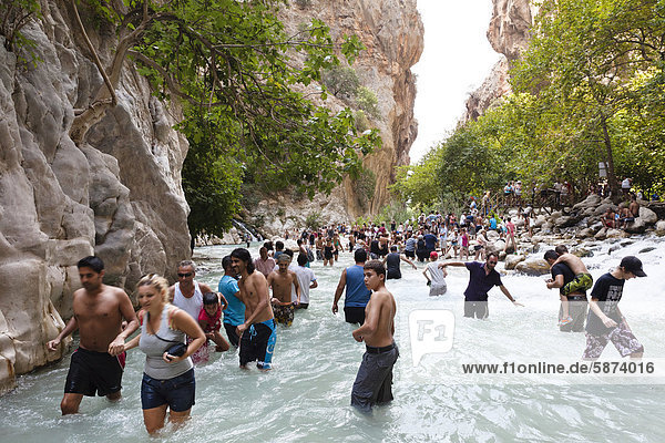Tourists walking in the water of the gorge  Saklikent Gorge near Tlos and Fethiye  Lycian coast  Lycia  Mediterranean  Turkey  Asia Minor