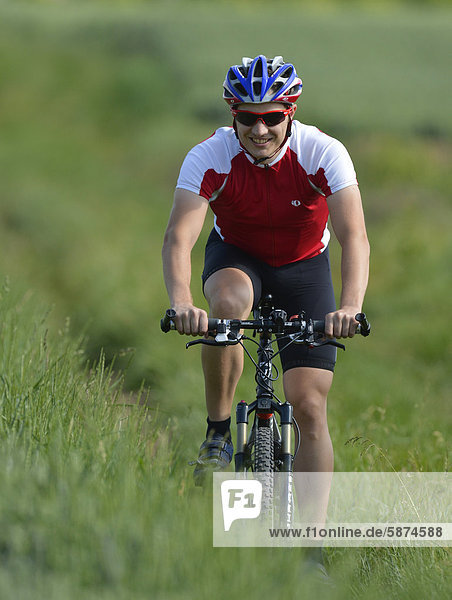 Cyclist riding a mountain bike  bicycle  Stuttgart  Baden-Wuerttemberg  Germany  Europe  PublicGround