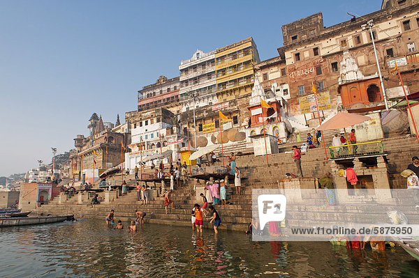 Bathers  boats  Ghats  holy stairs leading to the Ganges  city view in the early morning  Varanasi  Benares or Kashi  Uttar Pradesh  India  Asia