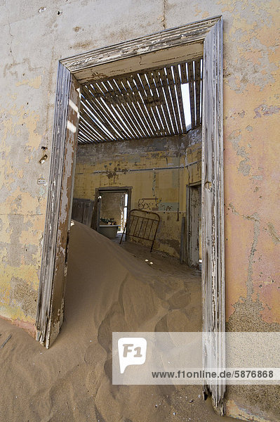 Desert sand and a door in a ruined house  abandoned diamond mine  Kolmanskop  Namibia  Africa