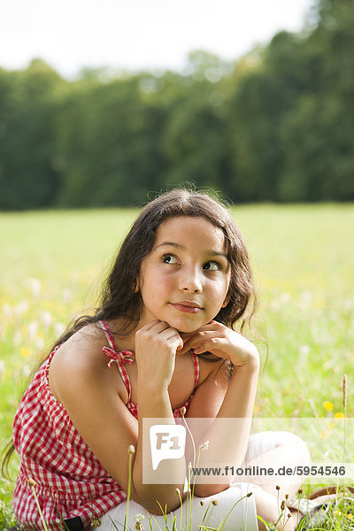 Girl sitting on meadow