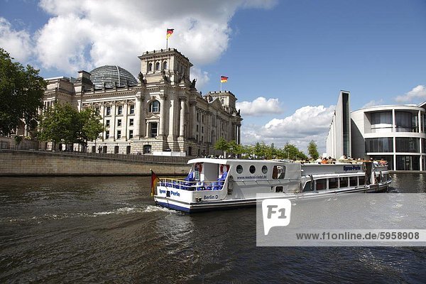 Tour boat on river cruise on the Spree River passing the Reichstag (Parliament)  Berlin  Germany  Europe