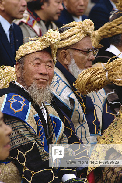 Portrait of an Ainu man in a group in traditional dress at the Marimo festival at Akan Kohan  Hokkaido  Japan  Asia