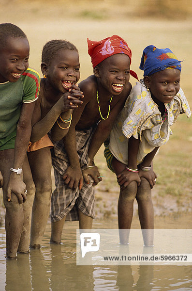 Group of young children smiling  paddling in the Niger River  Mali  West Africa  Africa