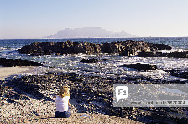 Woman on beach at Bloubergstrand looking across to Table Mountain  Cape Town  South Africa  Africa