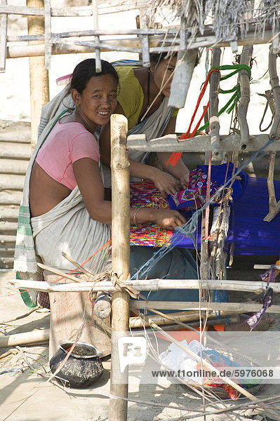 Assamese tribal village women spinning cotton at domestic loom  Majuli Island  Assam  India  Asia