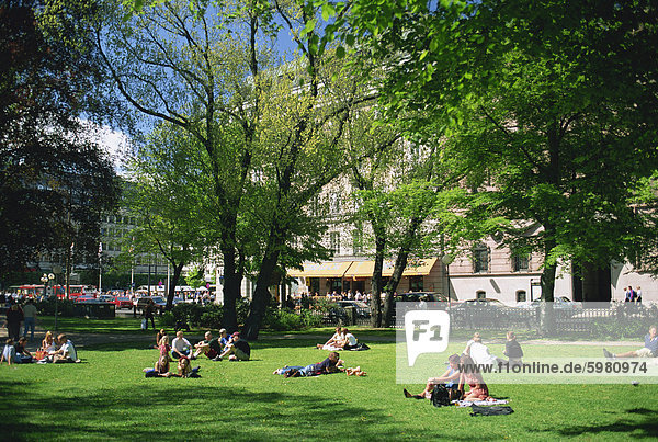 Groups of people in Berzelii Park in the city centre of Stockholm  Sweden  Scandinavia  Europe