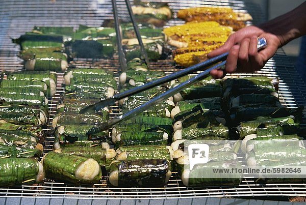 Sticky rice wrapped in banana leaves on barbecue at Vietnamese Lunar New Year Festival in Footscray,  a suburb of Melbourne,  Victoria,  Australia,  Pacific