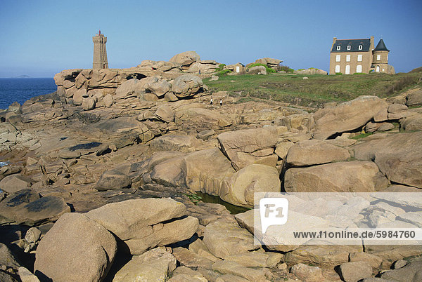 Rocks on the coast and the lighthouse at Ploumanach  on the Cote de Granit Rose  on the Cotes d'Amor  Brittany  France  Europe