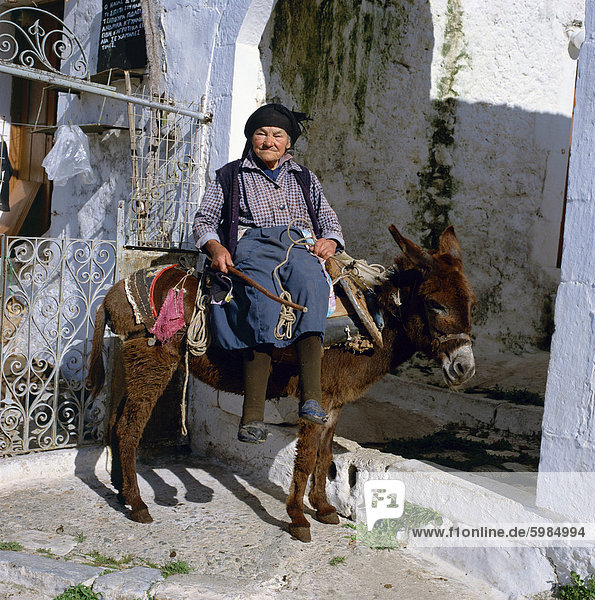 Portrait einer alten Frau sitzend auf einem Esel in einem Dorf in Griechenland  Europa