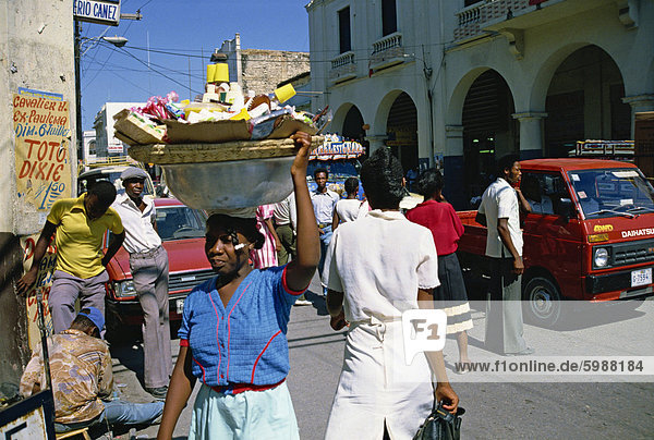 Street scene  including woman carrying goods on head  Port au Prince  Haiti  Caribbean  Central America