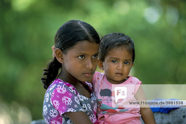 Portrait of two children  Dharavandu Island  Baa Atoll  Maldives  Asia