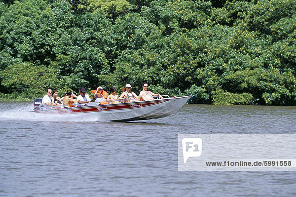 Tourists in speed boat riding on Rio Preguica  Parque Nacional dos Lencois Maranhenses  Barreirinhas  Lencois Maranhenses  Brazil  South America