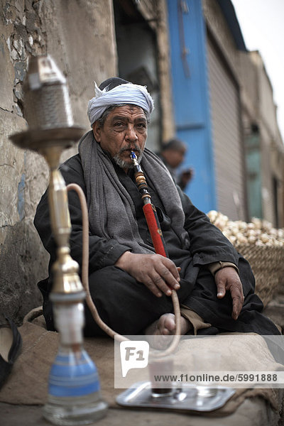 A man smokes sheesha in the Khan al-Khalili area of Cairo  Egypt  North Africa  Africa