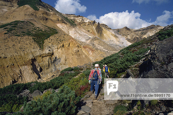 A group of hikers on a path in the Daisetsuzan Range on the island of Hokkaido  Japan  Asia