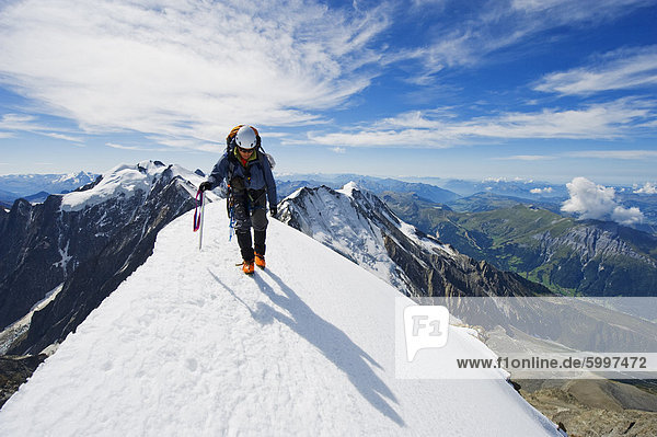 Climber on snow ridge  Aiguille de Bionnassay. on the route to Mont Blanc  French Alps  France  Europe