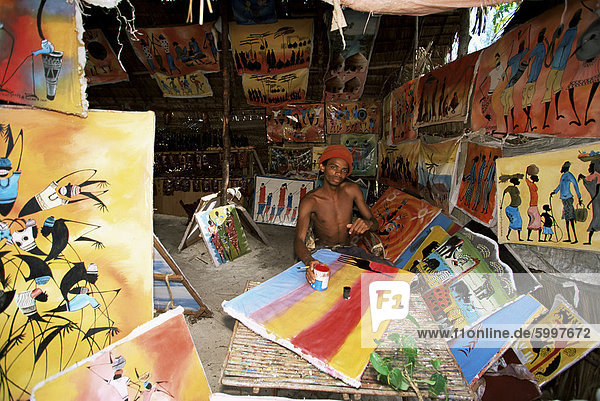 Local artist with his Tingatinga paintings  Zanzibar  Tanzania  East Africa  Africa