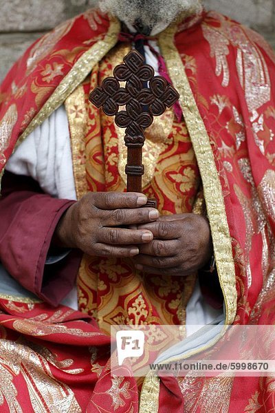 Coptic Orthodox priest holding a cross  Addis Ababa  Ethiopia  Africa