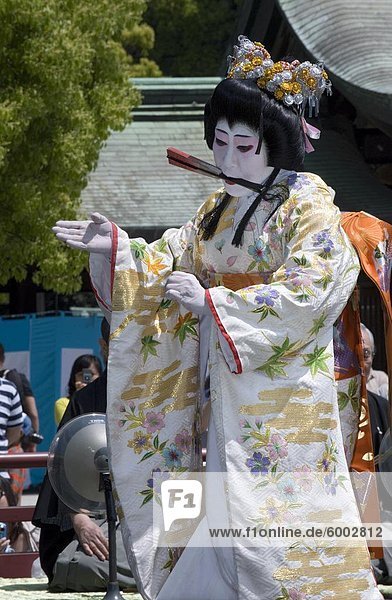 Man dressed as a woman performing classical Japanese dance called hobu at Meiji Jingu shrine  Tokyo  Japan  Asia