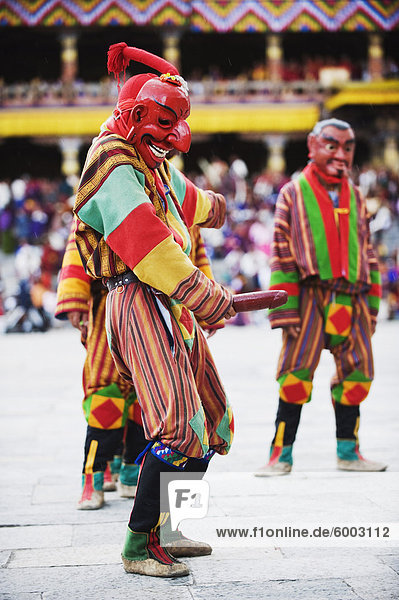 Dancer holding wooden penis  Autumn Tsechu (festival) at Trashi Chhoe Dzong  Thimpu  Bhutan  Asia