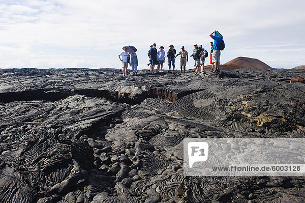 Tourists walking on lava flow on Isla Santiago  Sullivan Bay  Galapagos Islands  UNESCO World Heritage Site  Ecuador  South America