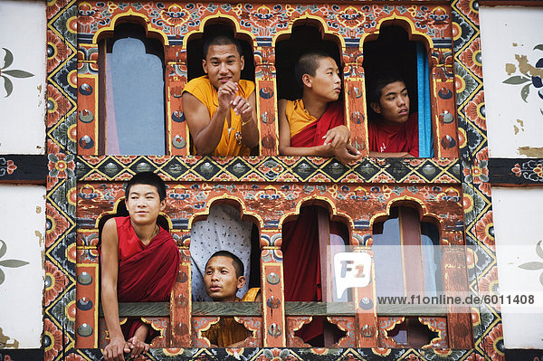 Young monks at a window  Chimi Lhakhang dating from 1499  Temple of the Divine Madman Lama Drukpa Kunley  Punakha  Bhutan  Asia