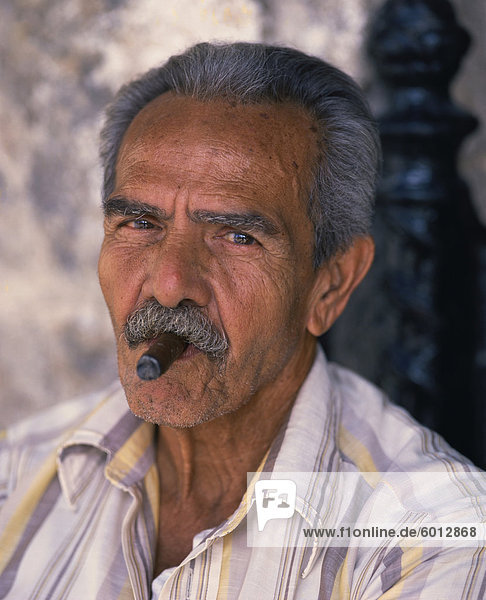 Kopf und Schultern Porträt einer Gehhilfe Mann mit Schnurrbart raucht eine Zigarre  Blick in die Kamera  Habana (Havanna)  Kuba  Westindische Inseln  Caribbean  Central America
