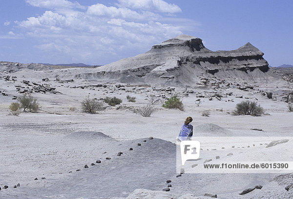 Frau geht zu Cancha de Bochas (Ausdehnung der runden Steine) in Parque Provincial Ischigualasto (Valle De La Luna)  Argentinien  Südamerika