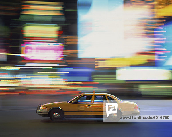 Gelbes Fahrerhaus treibende Vergangenheit verwischt Neon Lichter nachts am Times Square in New York  Vereinigte Staaten von Amerika  Nordamerika