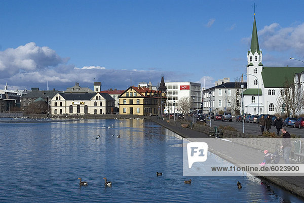 View over Tjornin (pond) to city behind Reykjavik Iceland Polar Regions