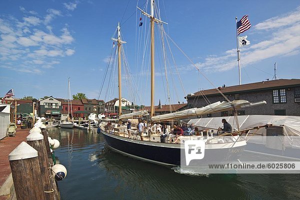 The 80 foot excursion schooner Aquidneck returning to Bowen's Wharf  established in 1760 and now a busy waterfront retail and tourist centre  Newport  Rhode Island  New England  United States of America  North America