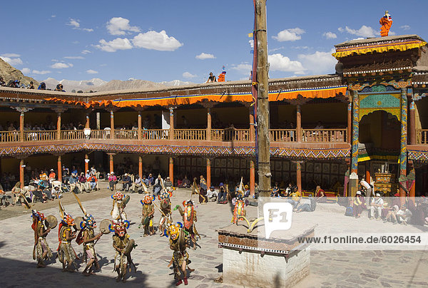 View from above of monastery courtyard with monks in traditional costumes dancing  Hemis Festival  Hemis  Ladakh  India  Asia