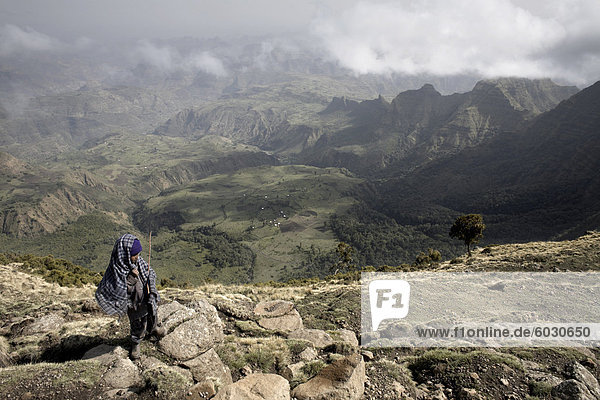 A small boy stands on the Northern Escarpment of the Simien Mountains National Park  Ethiopia  Africa