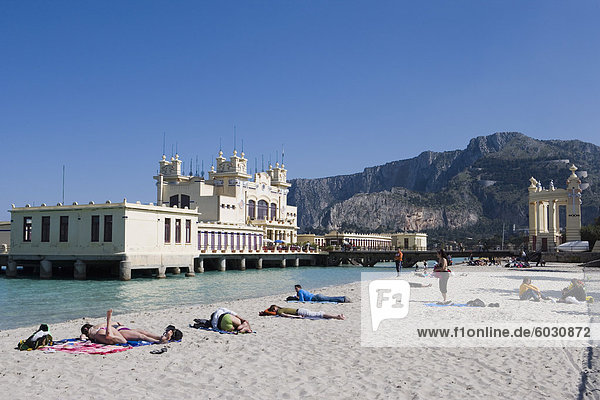 Sunbathers on beach near the pier Mondello Palermo Sicily Italy Europe