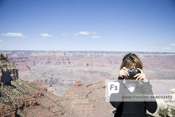Woman taking photos  Grand Canyon National Park  UNESCO World Heritage Site  Arizona  United States of America  North America