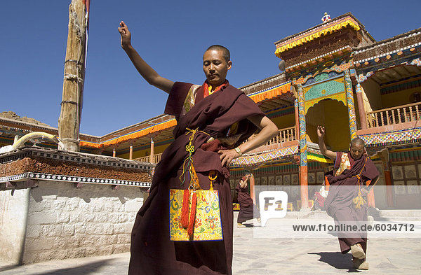 Group of monks dancing in the monastery courtyard rehearsing for Hemis festival  Hemis  Ladakh  India  Asia