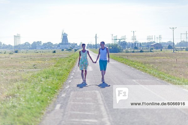 Couple walking down country road