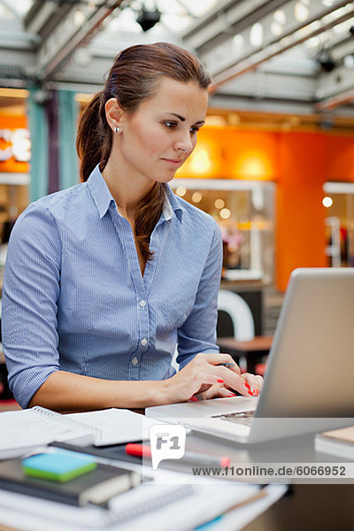 Portrait of young woman working with laptop