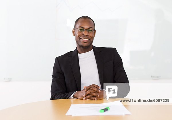 Portrait of smiling businessman sitting in office