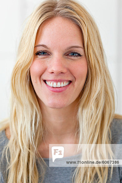 Portrait of blonde woman smiling indoors
