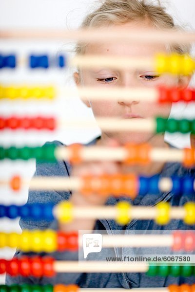 Girl behind colorful abacus