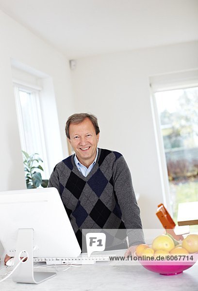Portrait of mature man using computer