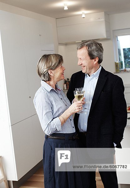 Mature couple celebrating with wine