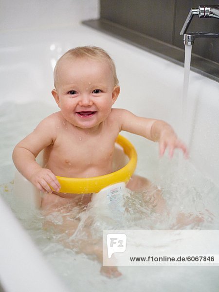 Smiling baby having bath