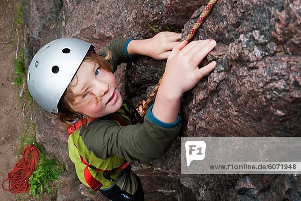 Boy climbing on rock