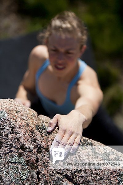 Woman climbing rock