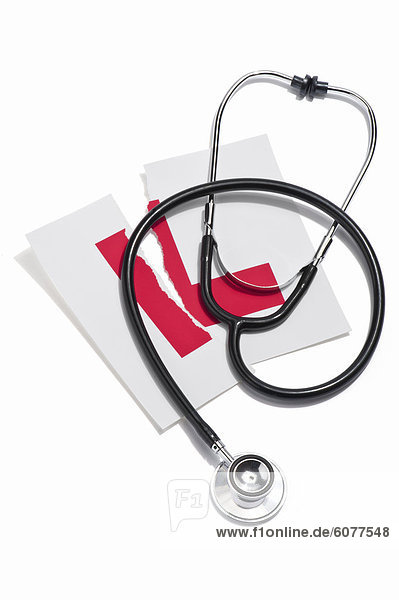 A doctors stethoscope and a torn learners permit sticker