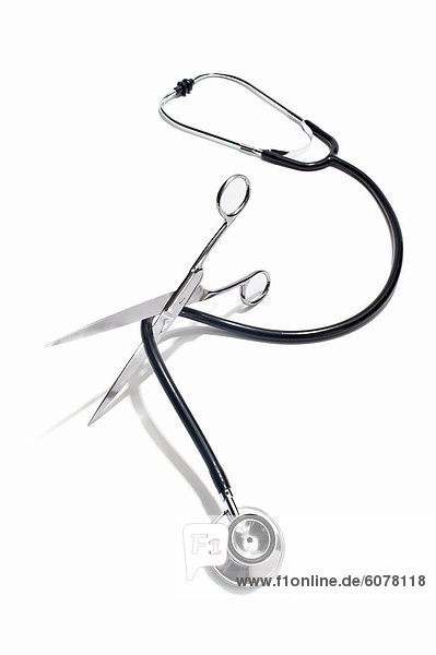 Scissors cutting through a stethoscope cable